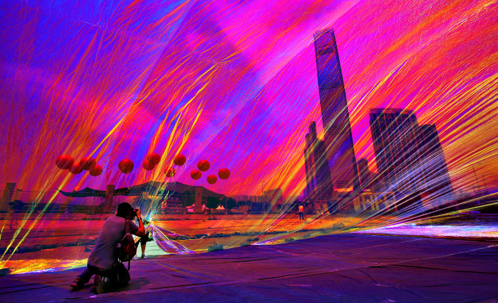 Apartment towers and the International Commerce Centre, tower at center, are seen through a work of art entitled "Poetic Cosmos of the Breath" by Argentine artist Tomas Saraceno, which is part of an exhibition called "Mobile M+: Inflation!" at the waterfront of West Kowloon Cultural District in Hong Kong Wednesday, April 24, 2013. (AP Photo/Vincent Yu)